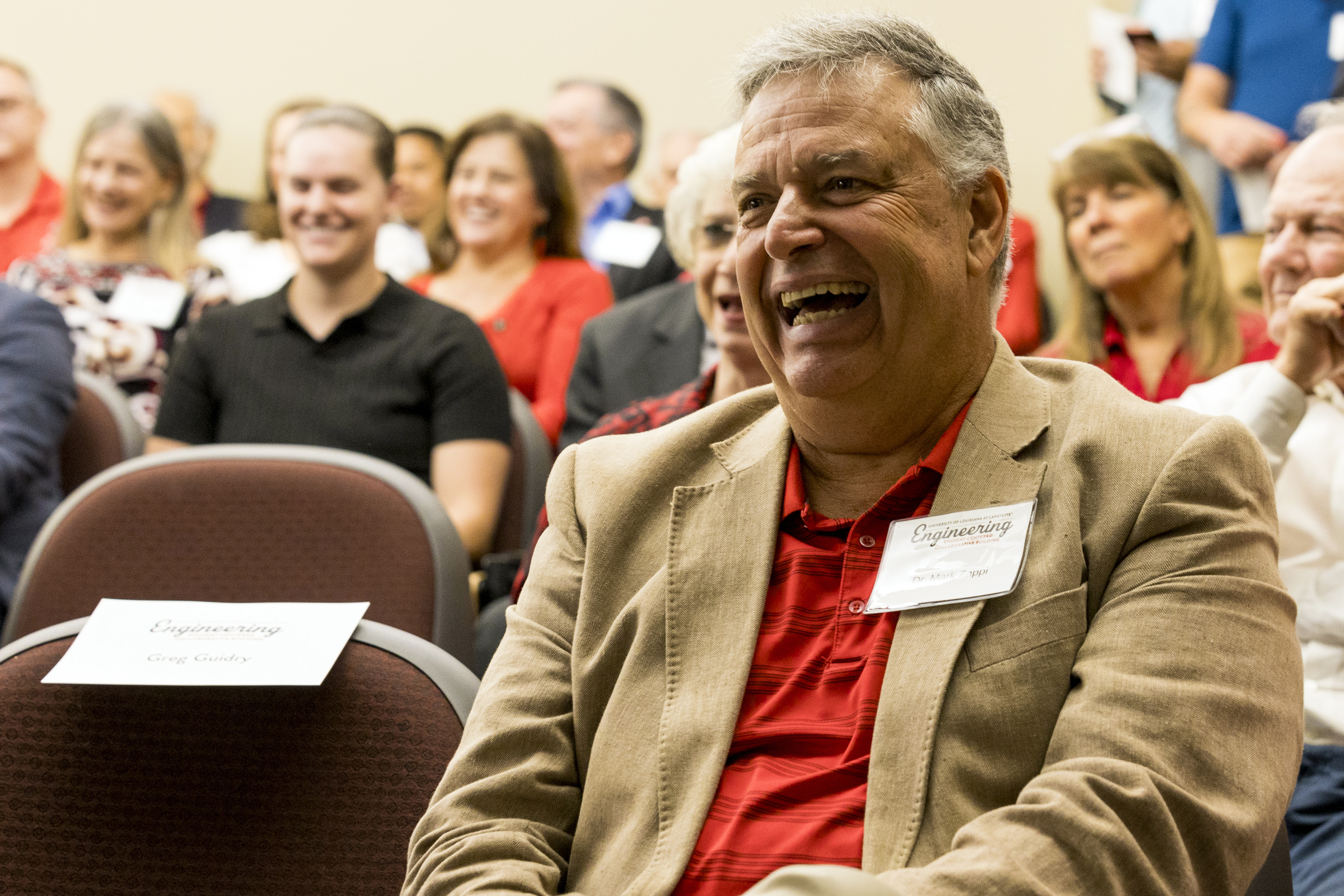 Dr. Mark Zappi sitting in audience, smiling as he is called to receive award.